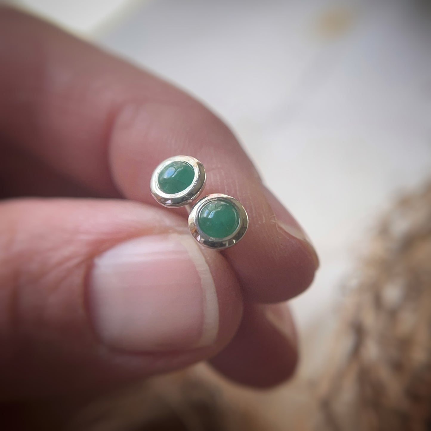 Emerald bezel set stud earrings in sterling silver
