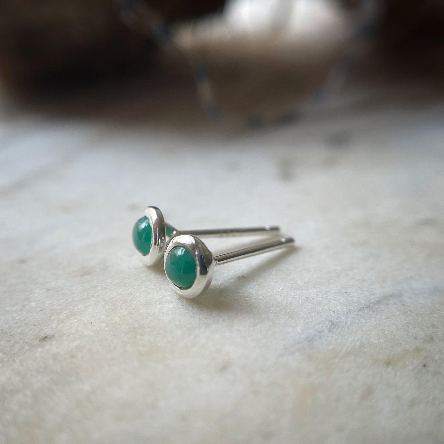 Emerald bezel set stud earrings in sterling silver