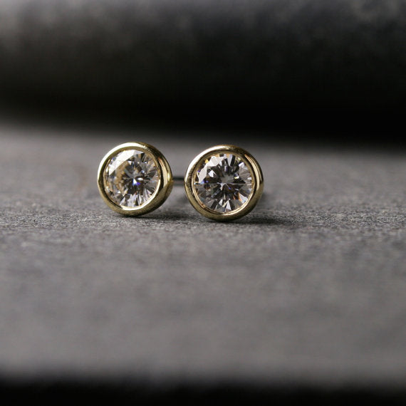 a pair of yellow gold Moissanite stud earrings