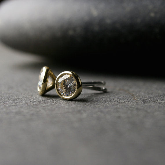 a pair of yellow gold Moissanite stud earrings