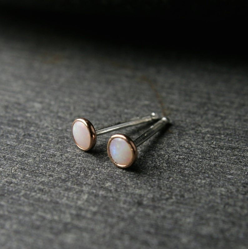 Australian opals bezel set in 14k rose gold. Shown from the top with sterling silver posts.