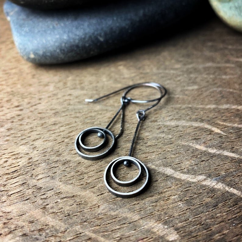 concentric circle hanging earrings with ear wires. They are oxidized sterling silver