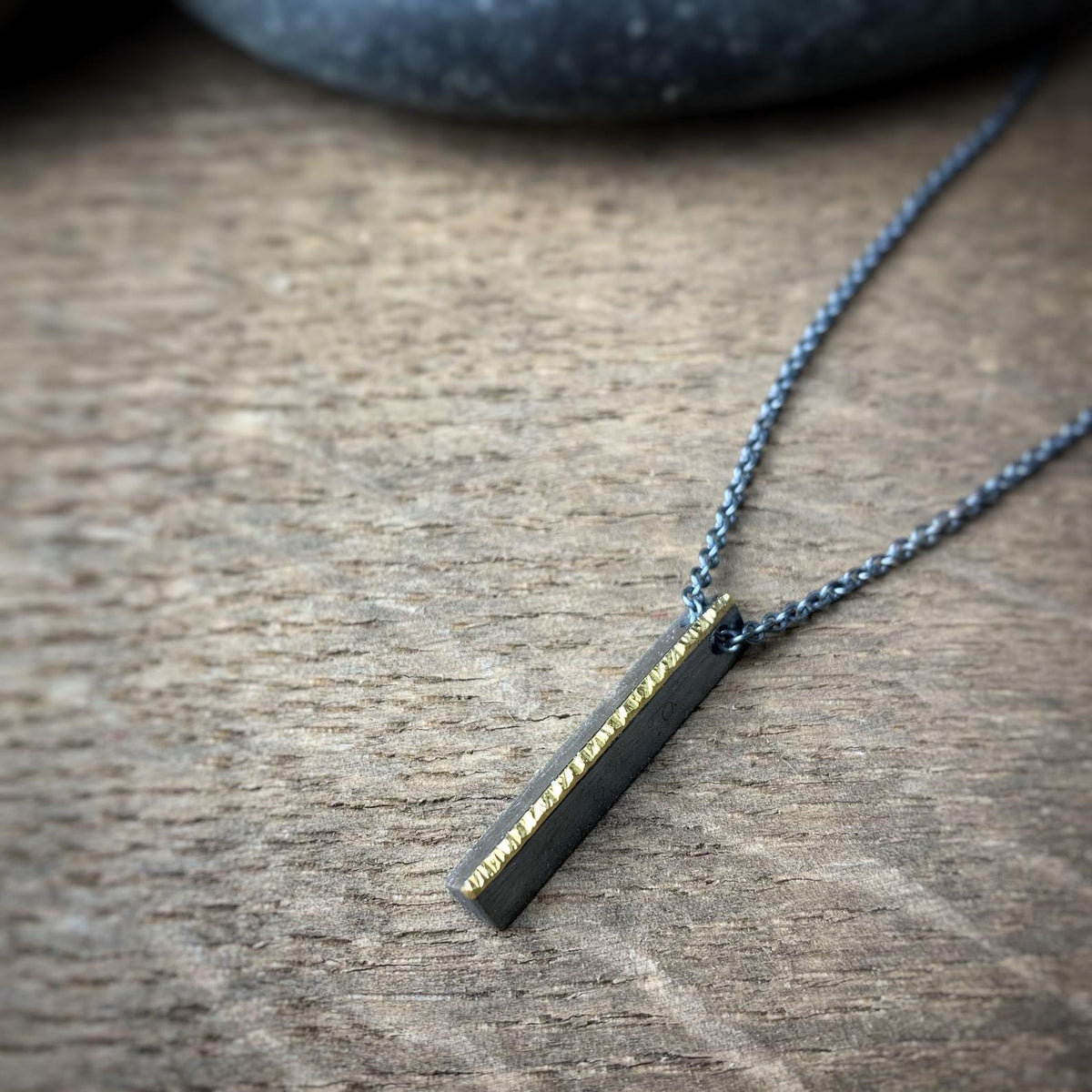 Minimal sterling silver bar pendant topped with hammered 18k yellow gold