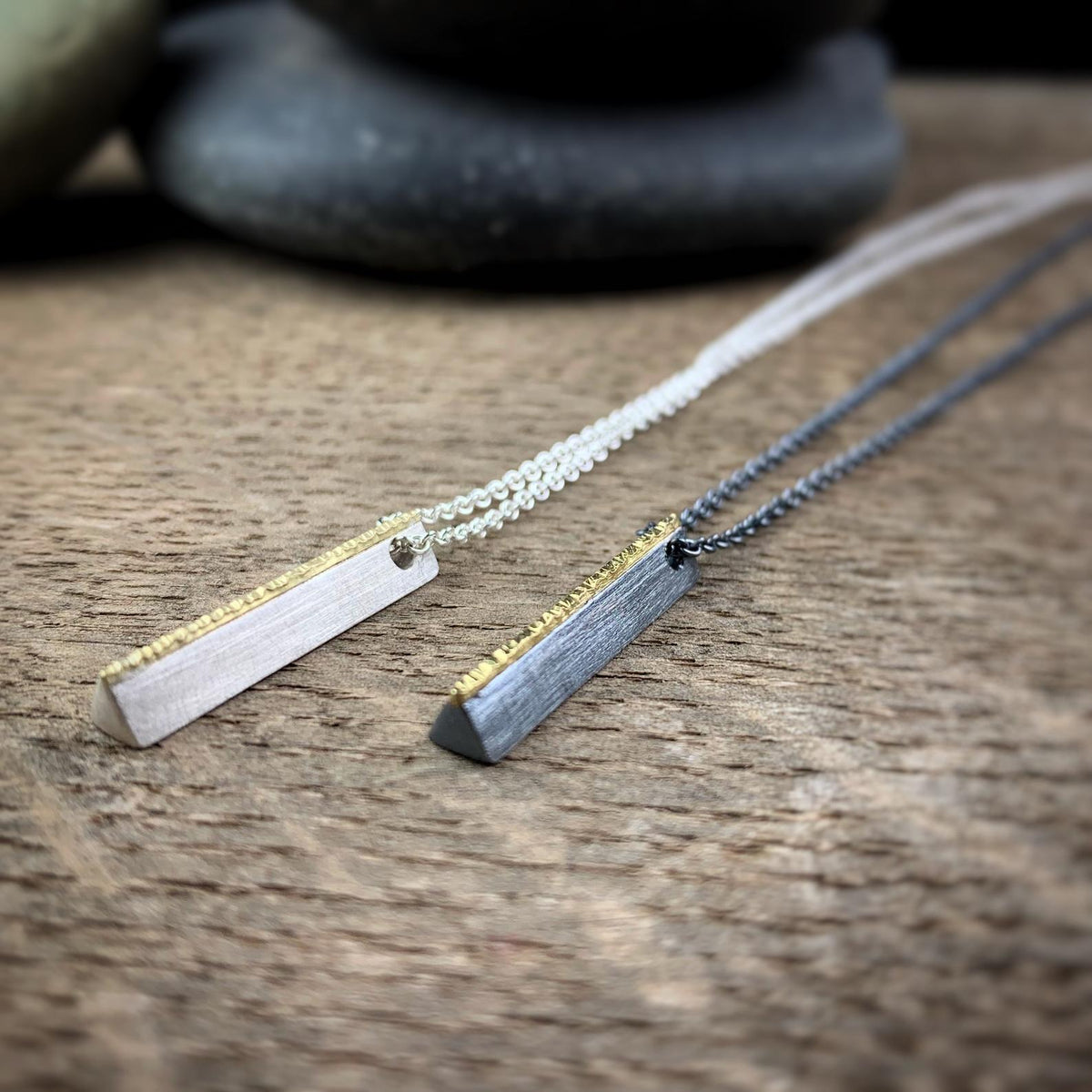 Minimal sterling silver bar pendant topped with hammered 18k yellow gold