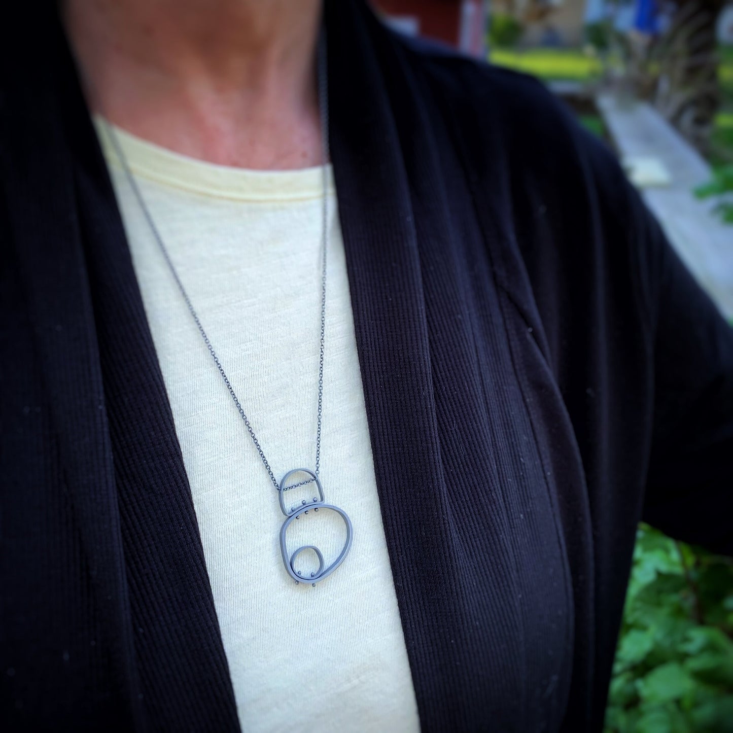 circle in circle modern pendant shown on a model
