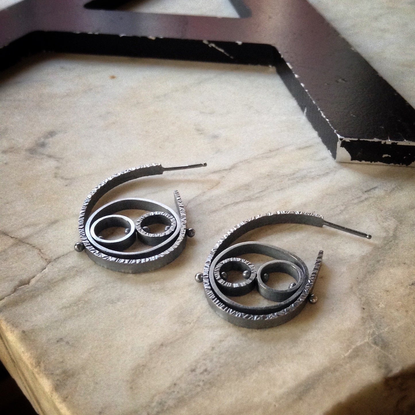 oxidized sterling silver hoop earrings with three textured circles