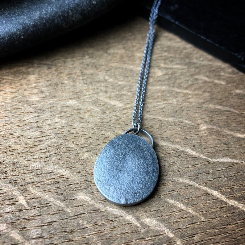 The back of the pendant with a pebble texture