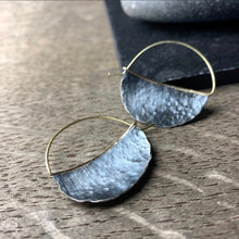 Load image into Gallery viewer, mezzaluna shaped hoop earrings in darkened silver with a hammered texture and 18k yellow gold ear wires

