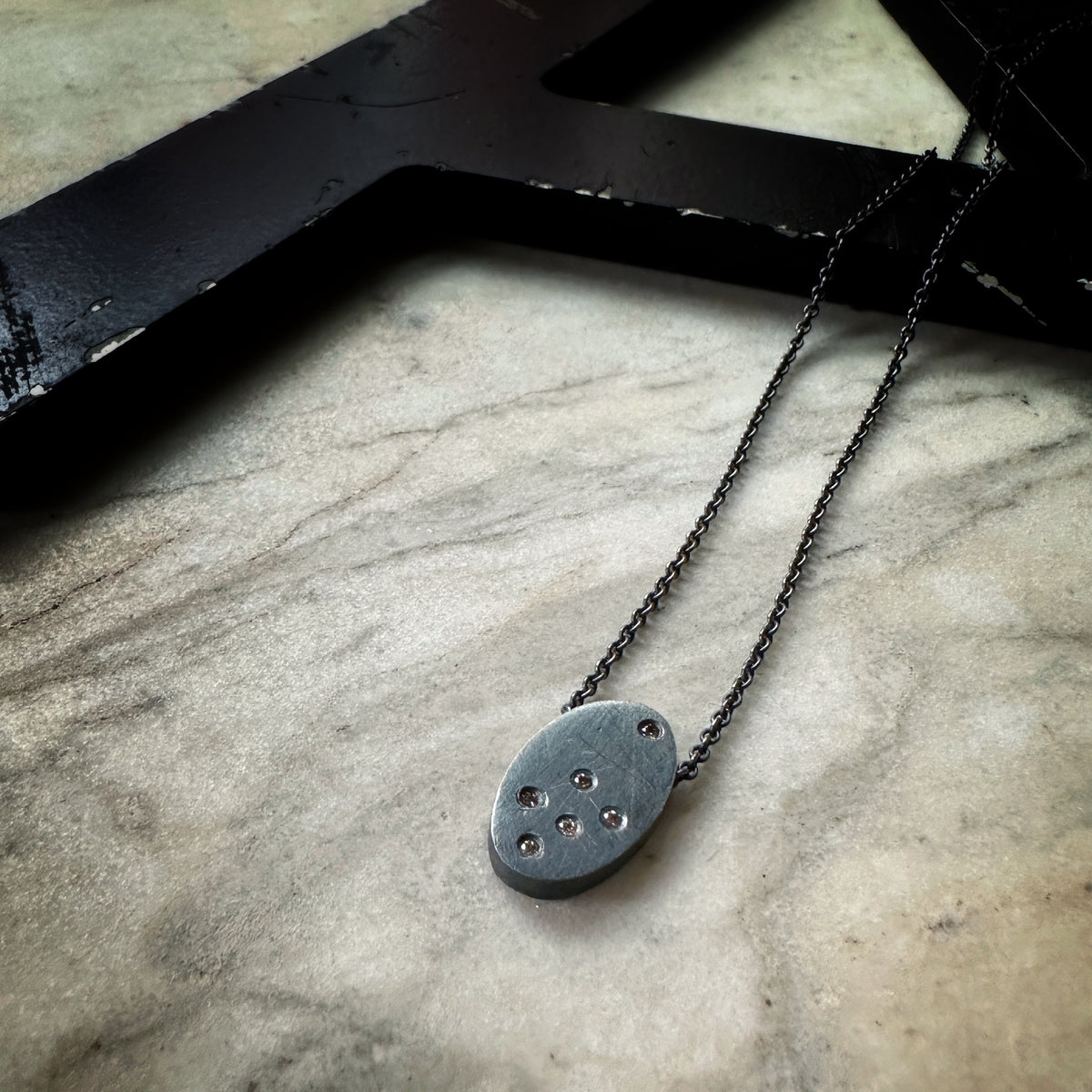 Oxidized sterling silver pendant scattered with tiny cognac diamonds