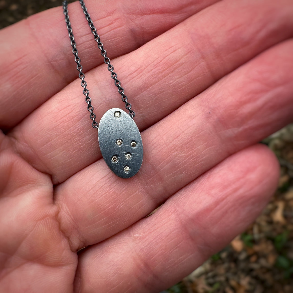Oxidized sterling silver pendant scattered with tiny cognac diamonds