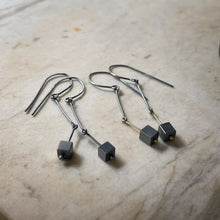 Load image into Gallery viewer, earrings in oxidized silver and gold wirh darkened silver cubes dangling at the end 
