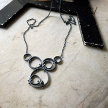 Load image into Gallery viewer, concentric circle and riveted pendant with bezel set hematite
