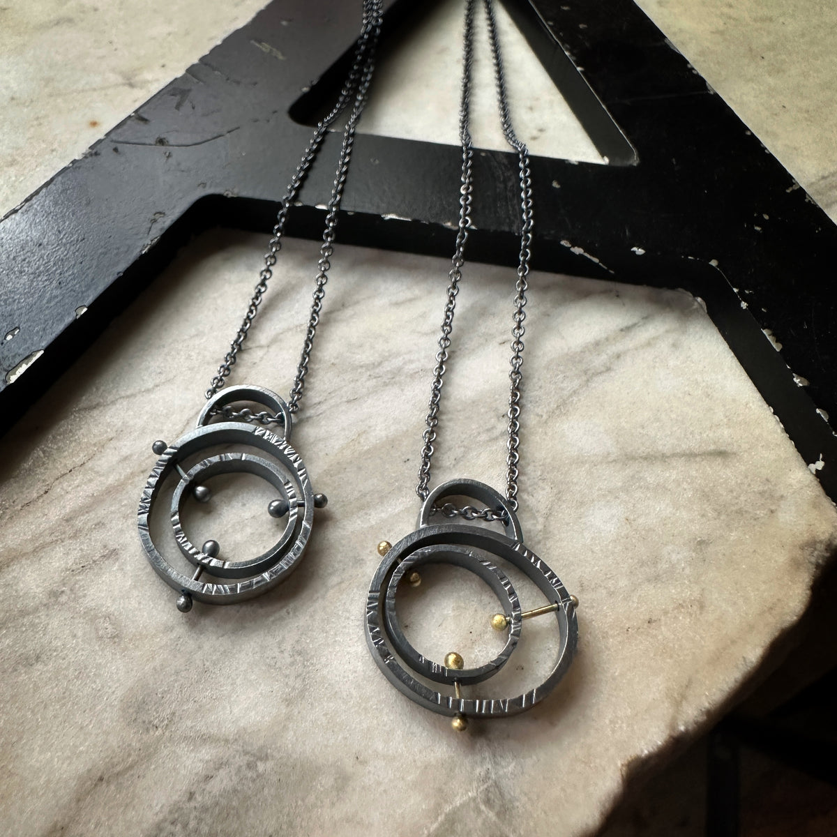 Mid-century atomic pendant in oxidized sterling silver with concentric pin detail