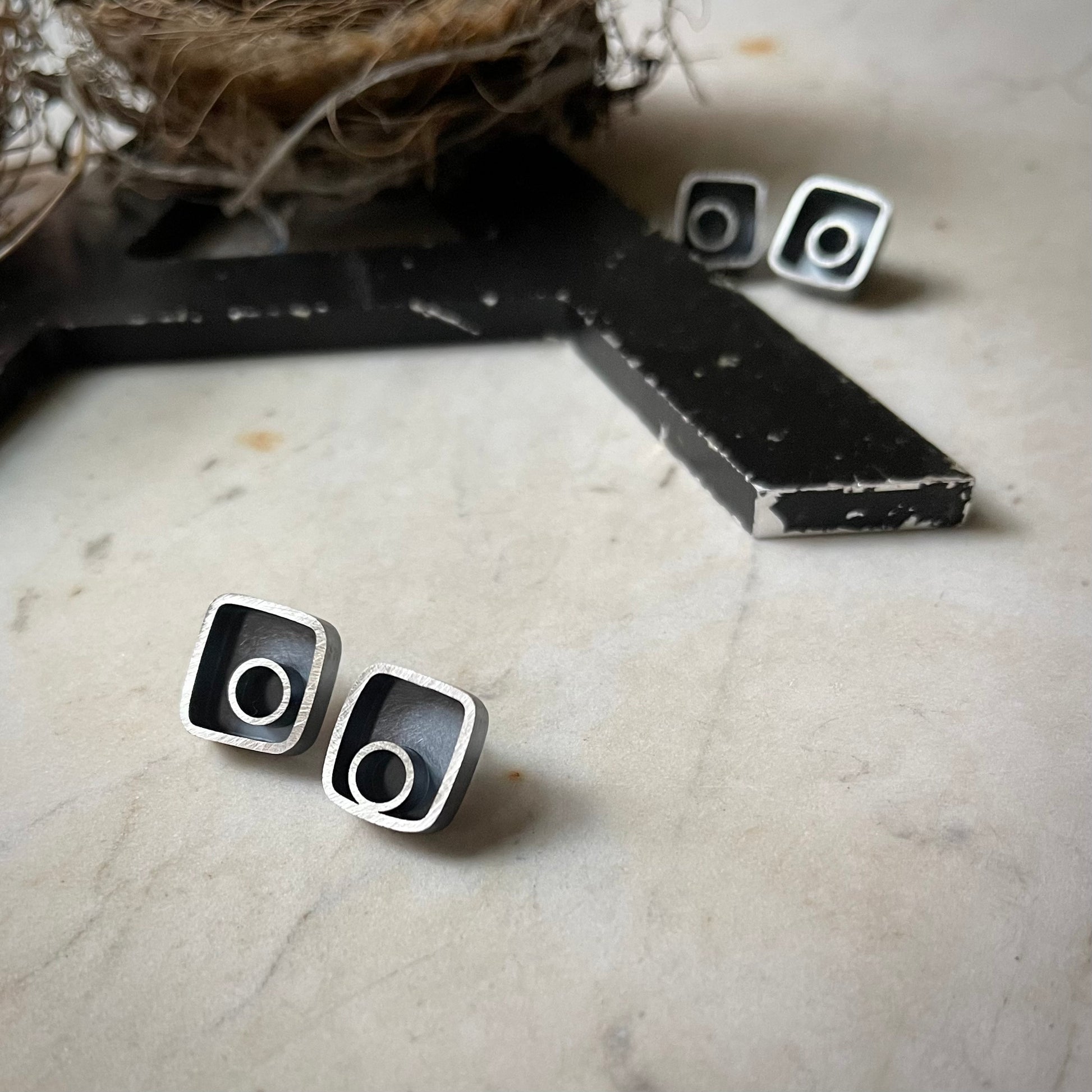 Small earrings with silver circle framed in a rectangle