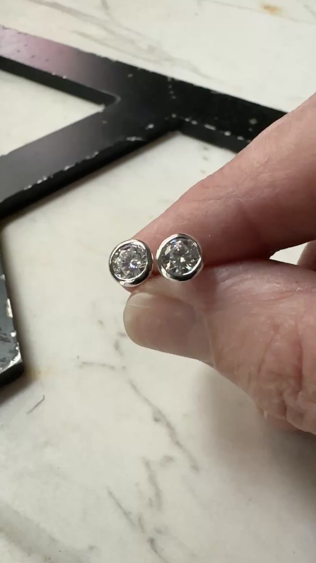 a video or 5mm bezel set sterling silver Moissanite stud earrings