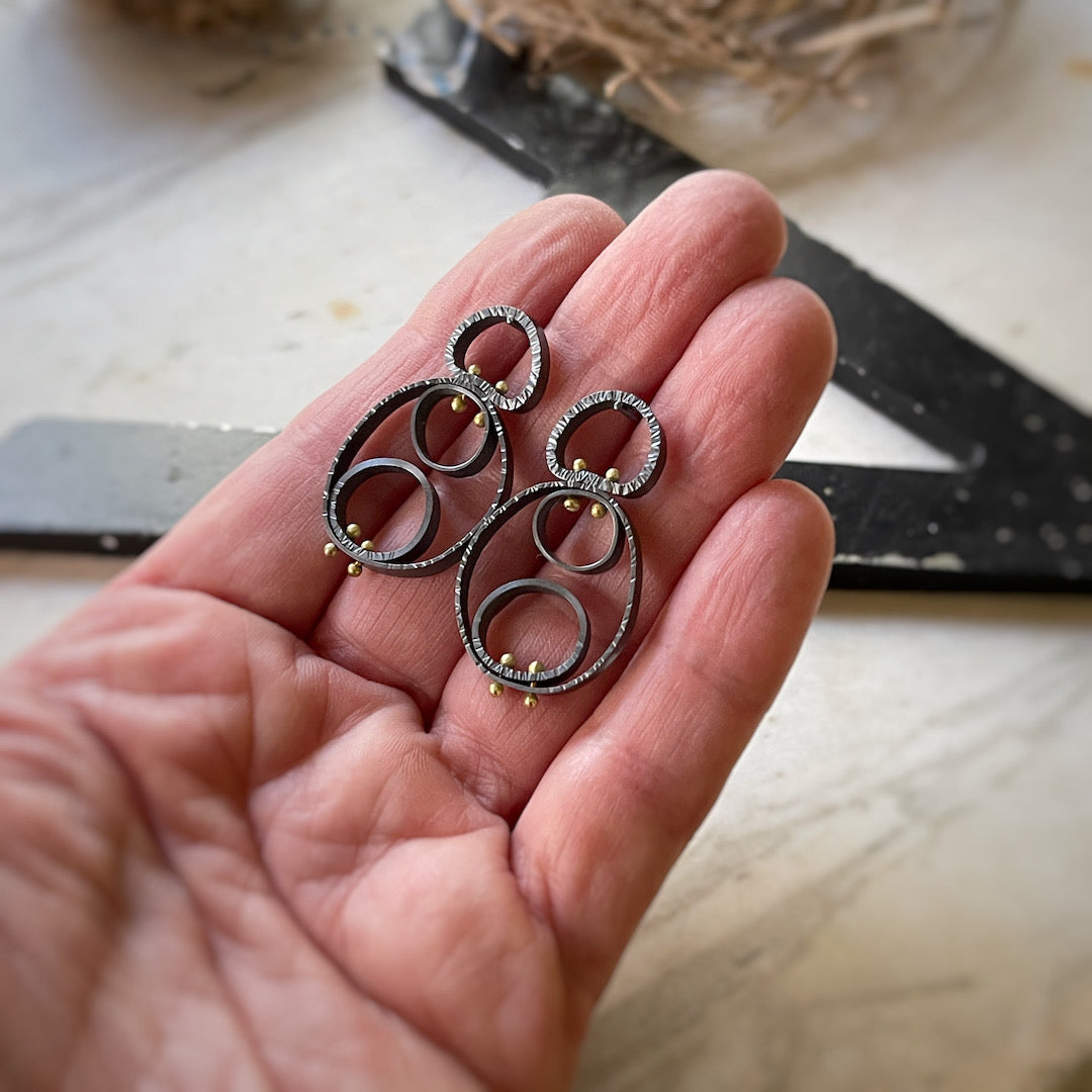 modern textured earrings made of circular cells pinned together with 18k yellow gold earrings