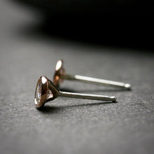 Load image into Gallery viewer, side view of 14k rose gold 3mm Moissanite stud earrings.  They are bezel set. 

