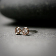 Load image into Gallery viewer, 14k rose gold 3mm Moissanite stud earrings.  They are bezel set. 
