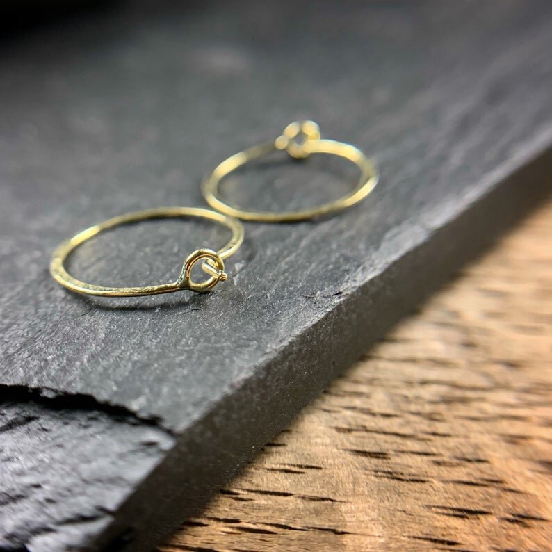 two small gold hoops.  Photo shows a small circular clasp. 