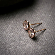 Load image into Gallery viewer, large 5mm Moissanite stud earrings in 14k rose gold bezels shown from the side to show posts
