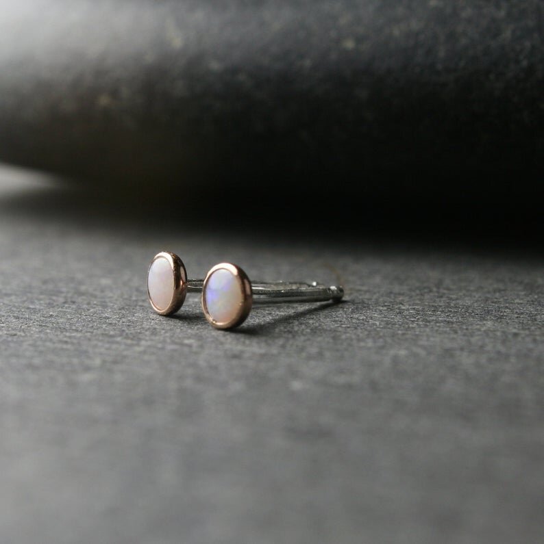 Australian opals bezel set in 14k rose gold shown from the side with sterling silver posts