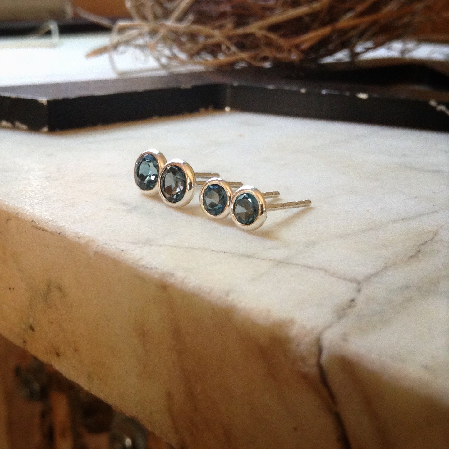 4mm and 5mm London blue topaz earrings together showing size difference