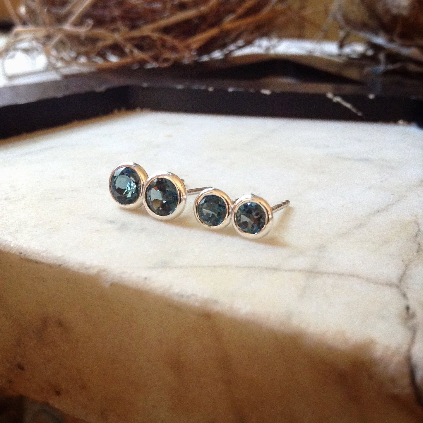 4mm and 5mm London blue topaz studs together showing size difference