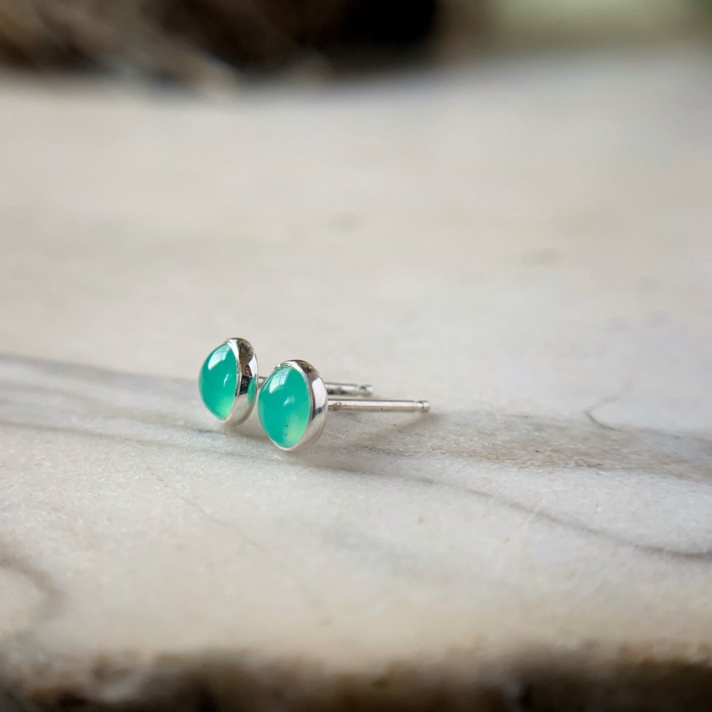 bezel set chrysoprase stud earrings shown from the side