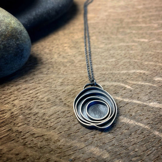 oxidized sterling silver pendant with concentric circles