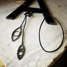 Load image into Gallery viewer, two leaf shaped pendants on a long leather cord.  This view shows a second way to wear this pendant
