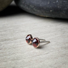 Load image into Gallery viewer, 5mm micro faceted garnet bezel set garnet stud earrings shown from the side with sterling silver posts
