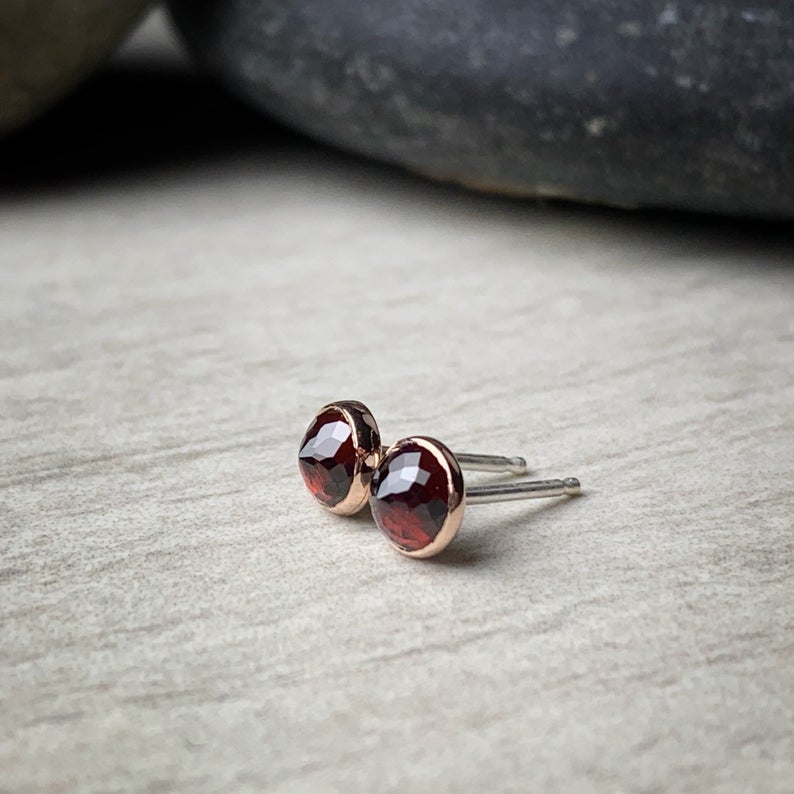 5mm micro faceted garnet bezel set garnet stud earrings shown from the side with sterling silver posts