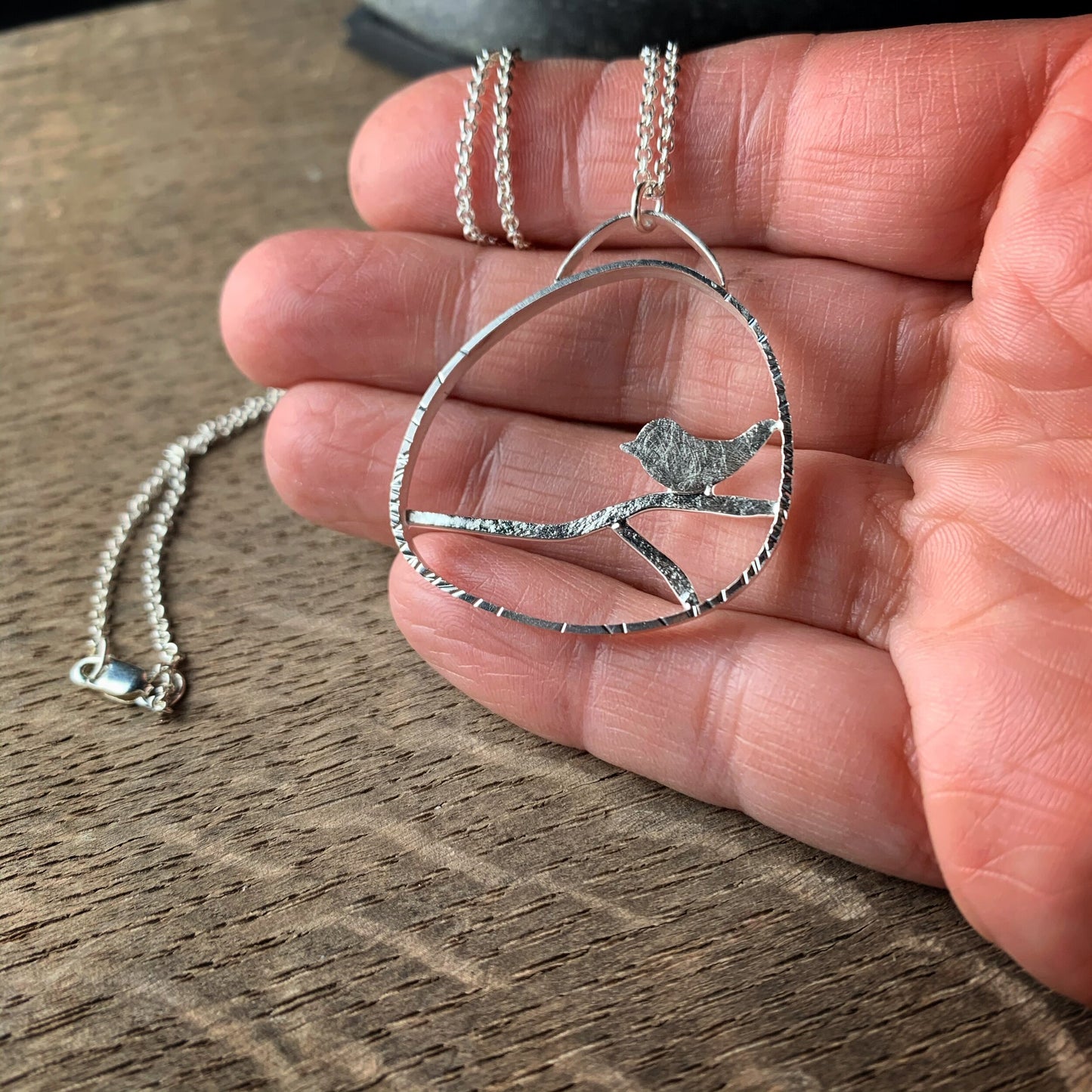 Sterling silver bird on a branch pendant