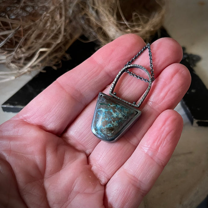 blue green and brown kite shaped stone in a oxidized sterling silver pendant