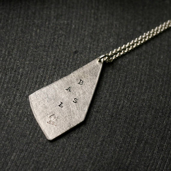 triangular shaped silver pendant with stamped initials