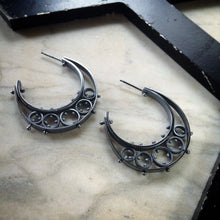 Load image into Gallery viewer, half moon hoop earrings in oxidized sterling sliver with several pinned circles
