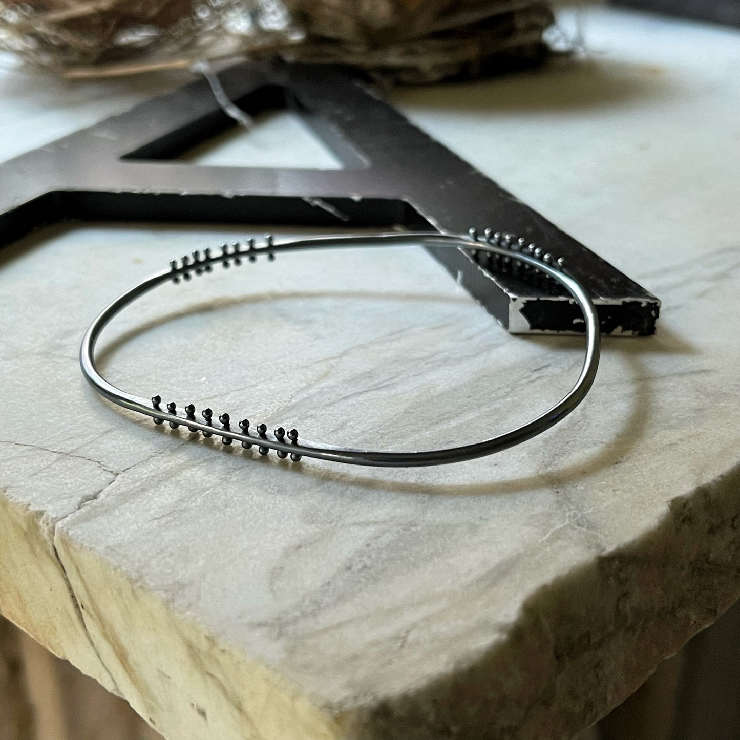 oxidized silver bangle bracelet with three stations of silver pins