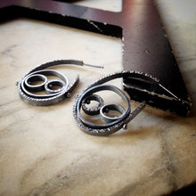 Load image into Gallery viewer, Modern textured hoops with circles within circles.  They are oxidized sterling silver
