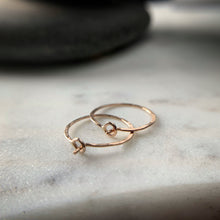 Load image into Gallery viewer, the circular clasps on two rose gold hammered hoop earrings
