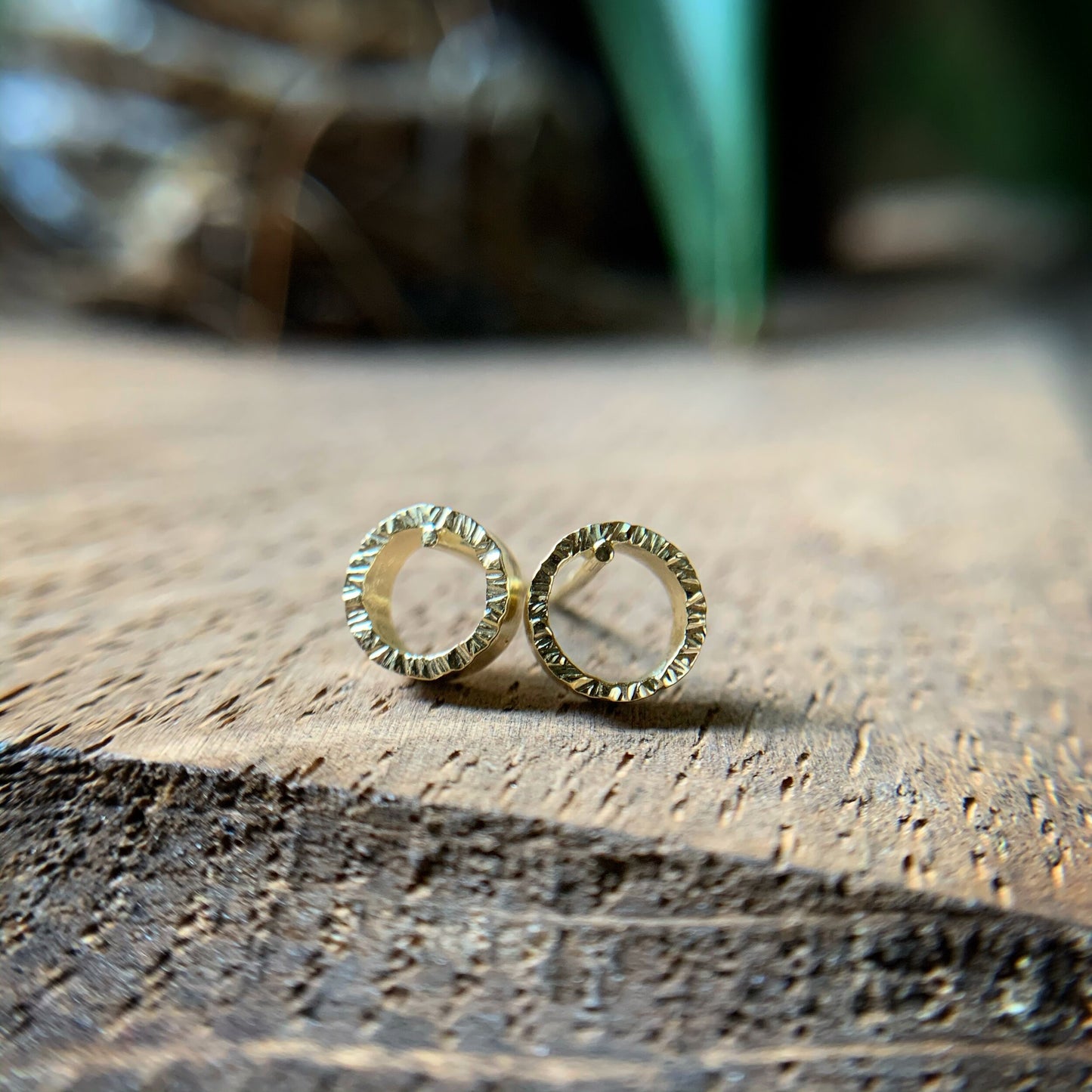 quarter inch yellow gold circles with hammered texture and solid gold posts and backs