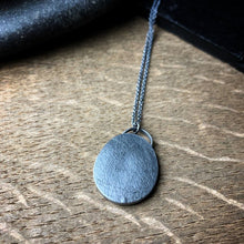 Load image into Gallery viewer, The back of the pendant with a pebble texture
