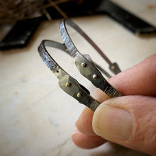 Load image into Gallery viewer, Two oxidized sterling silver bangle bracelets with silver an gold rivets.
