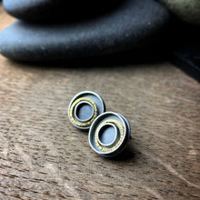 Load image into Gallery viewer, earrings with concentric circles with one 18k gold circle in each earring
