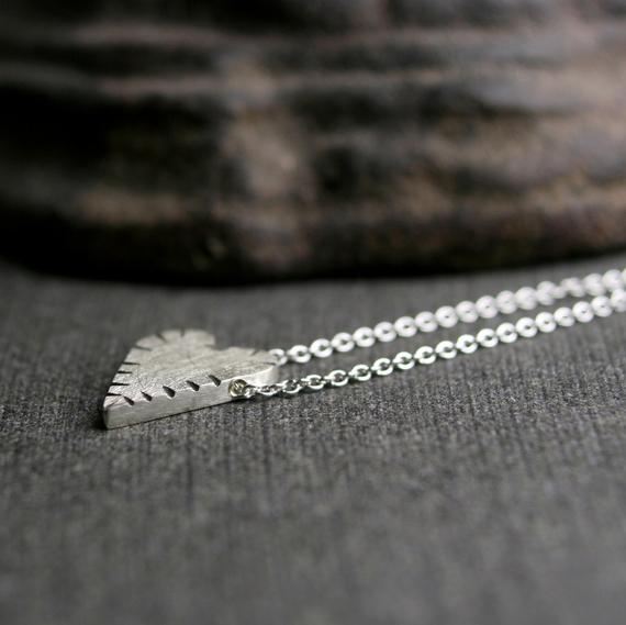 Sterling silver tiny cut heart pendant, cut texture with a brushed finish