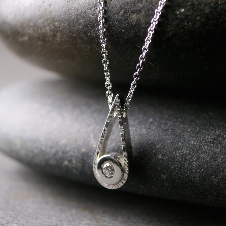 Sterling silver teardrop shaped pendant with a small diamond