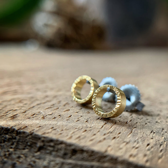 quarter inch yellow gold circles with hammered texture and oxidized silver posts and backs