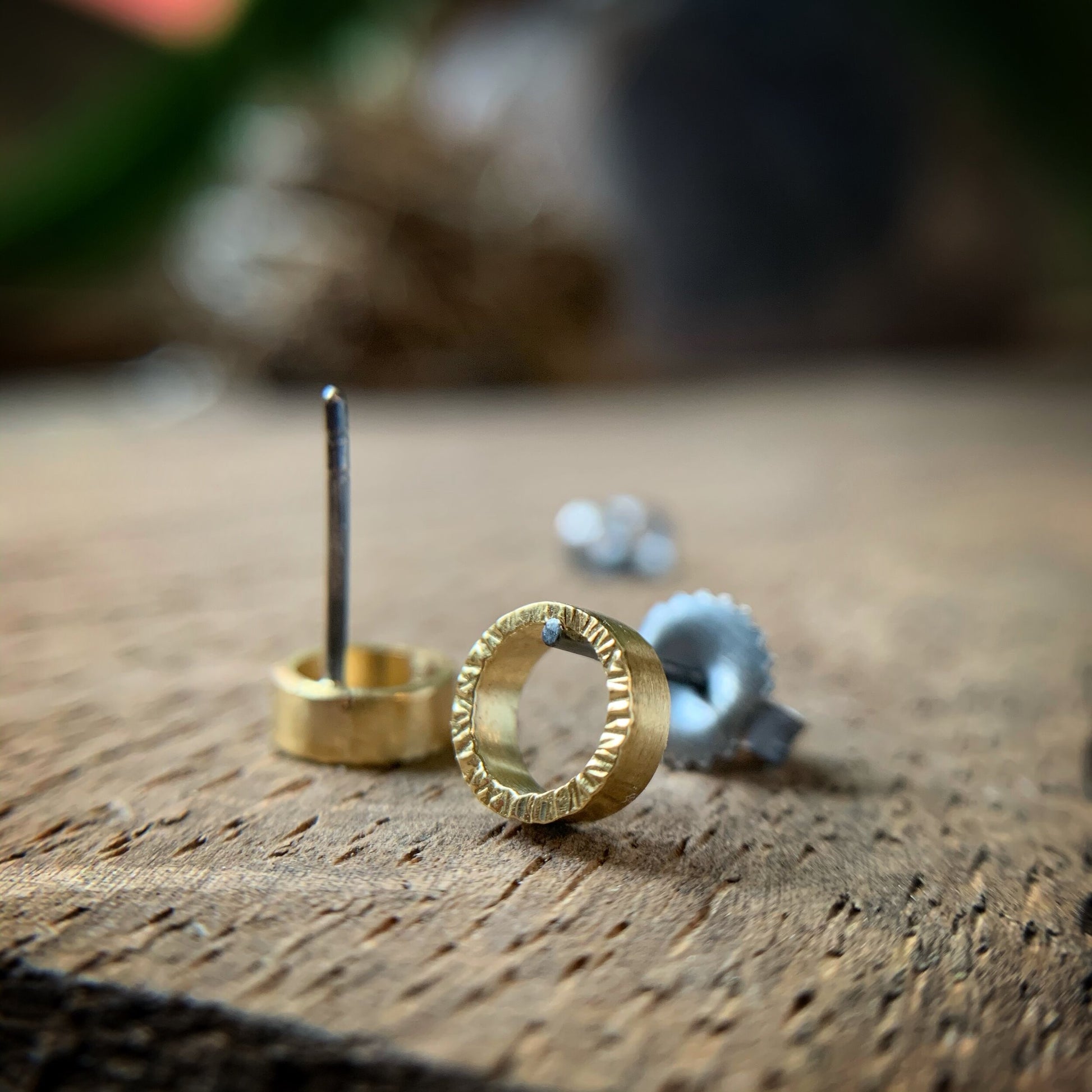 quarter inch yellow gold circles with hammered texture and oxidized silver posts and backs.  