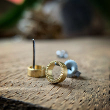 Load image into Gallery viewer, quarter inch yellow gold circles with hammered texture and oxidized silver posts and backs.  
