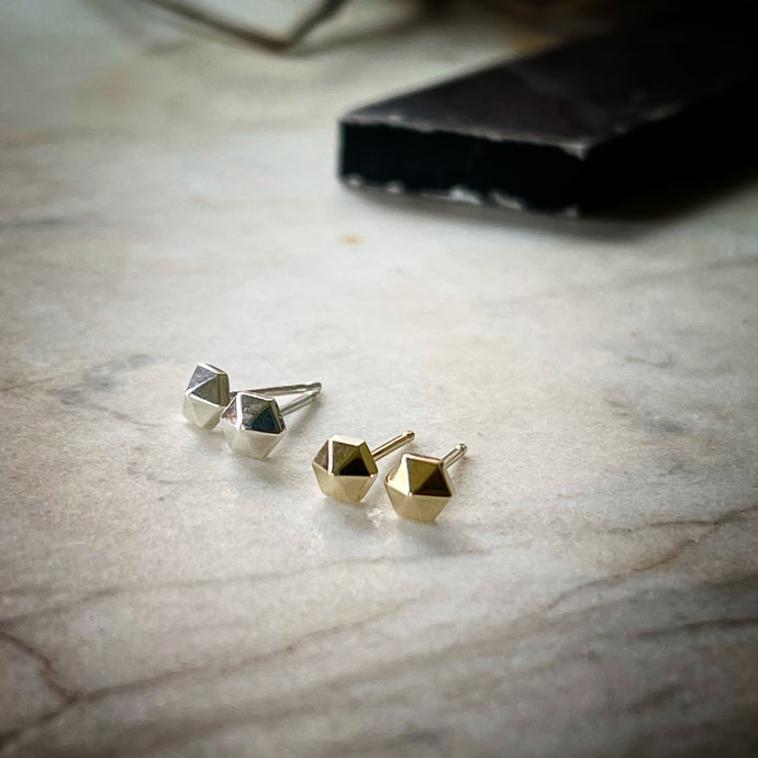 tiny hexagonal stud earrings.  A pair in sterling silver and a pair in 14k yellow gold