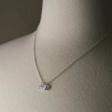 Load image into Gallery viewer, tiny initial pendants hand stamped shown on a model for scale
